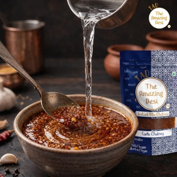 Pouring water into a bowl of TAD instant garlic chutney powder to prepare the mix.